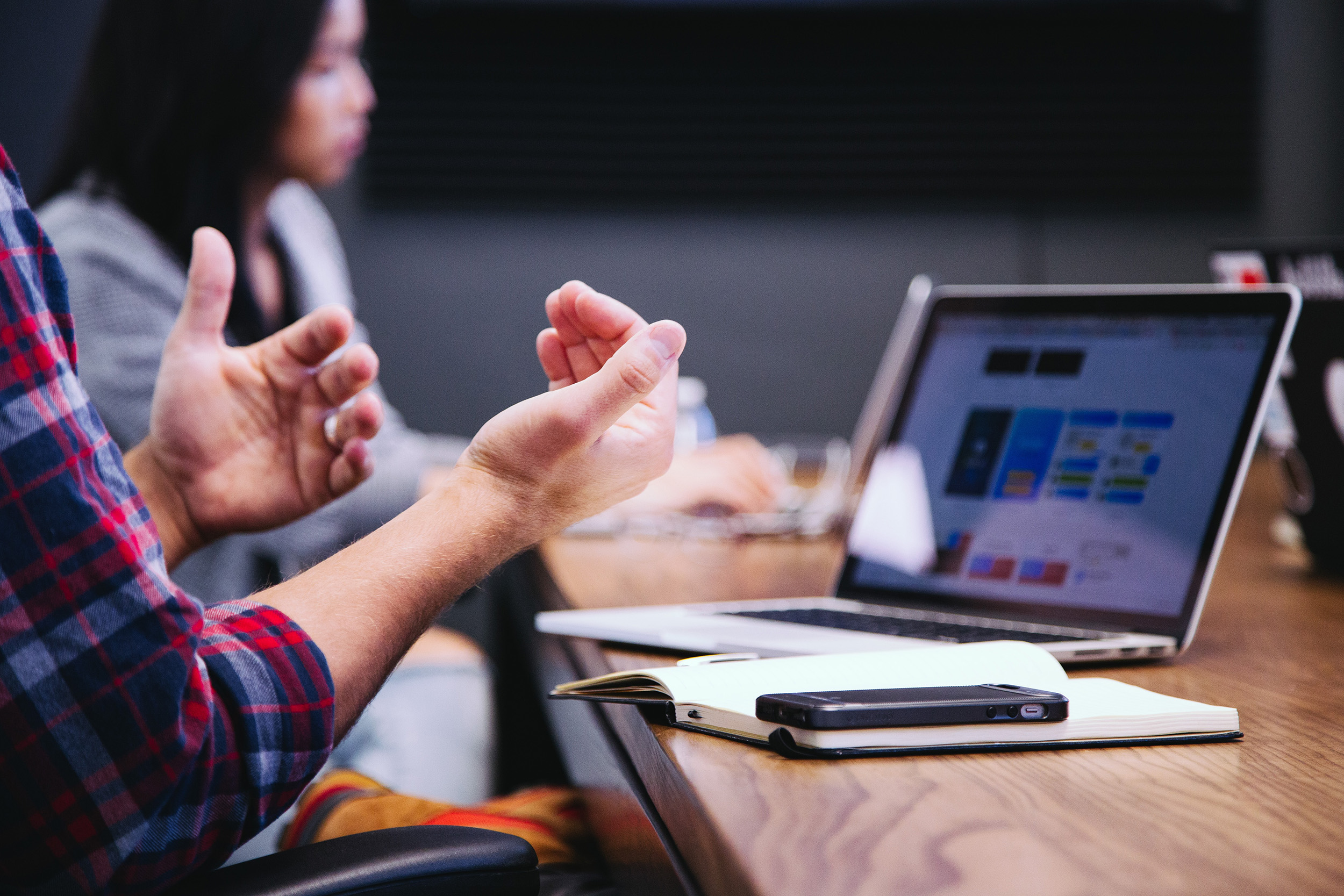 Expressive hands at desk with laptop